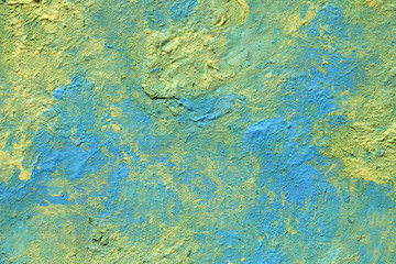 Fototapeta na wymiar The texture of the paint is yellow and blue. Background for a postcard on a holiday. Strips with a volume of different colors.