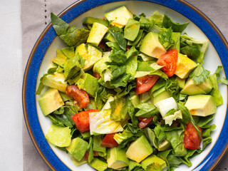 Healthy avocado spinach tomato salad. Gourmet dieting