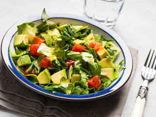 Healthy avocado spinach tomato salad. Gourmet dieting