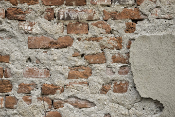 The bricks in the wall of an old ruined building