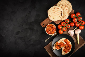 Pita bread with vegetable spread- mediterranean kitchen style. Top view. Copy space.