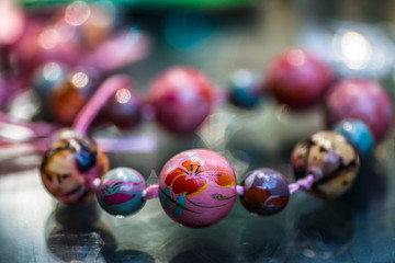 Colorful handmade necklace on a glass table