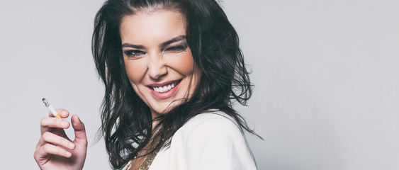 Beautiful woman portrait laughing and winking while smoking cigarette, letterbox