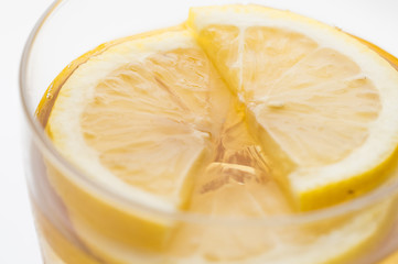 Glass of lemon ice tea isolated on white background. close up