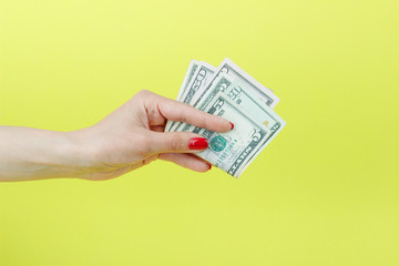 American dollars in the woman's hand, yellow background