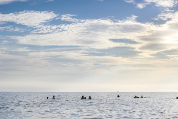 Fototapeta premium People in the sea with blue sky and sunlight in the evening.