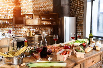 pizza, wine and vegetables ready for party