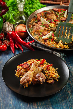 Traditional paella with chicken legs, sausage chorizo and vegeta