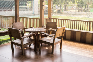 Table corner on wooden terrace, vintage wood furniture