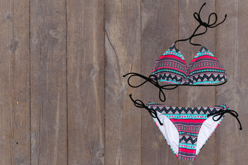 swimsuit on wooden background. top view