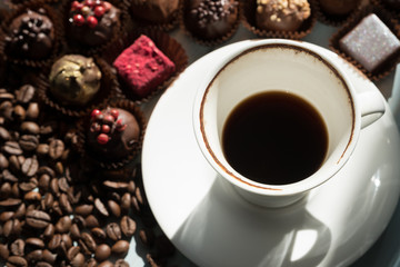 A cup of coffee and chocolate sweets