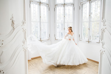 The beautiful bride stands in the room