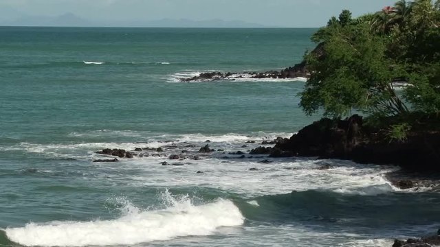 Waves crashing ashore on a headland at La Toc Beach in St Lucia on a windy day 