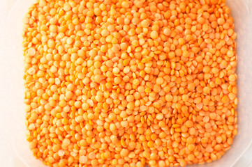 Lentils red color on wooden table
