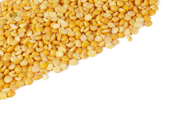 Dry yellow split peas isolated on white.