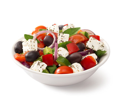 Greek salad in a bowl, on white background

