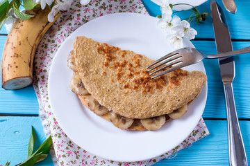 Healthy breakfast - pancake from oatmeal with banana and cheese