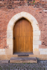 Old wooden door of the Catholic church in Bohemia