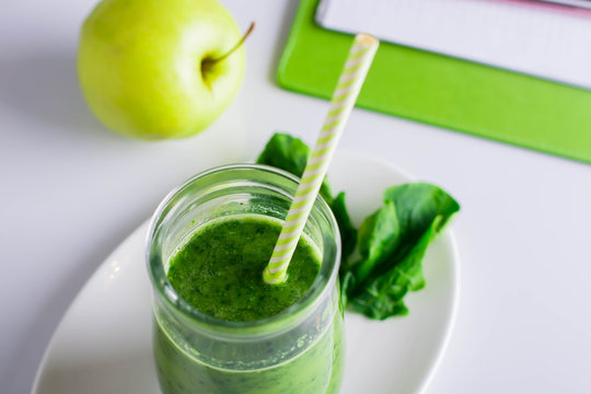Healthy Drink Smoothie from Green Spinach and Apples in jar on white table. Vegetarian and Diet Detox Drink Concept. Copy space, horizontal image