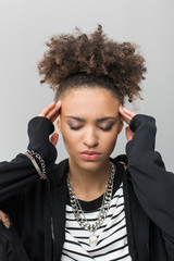 portrait of african american girl with headache isolated on grey