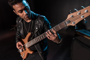 Electric guitar player performing hard rock music with bass guitar on stage