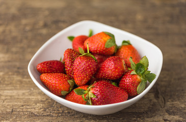 Freshly Handpicked Strawberries in a Bowl on White Wooden Table