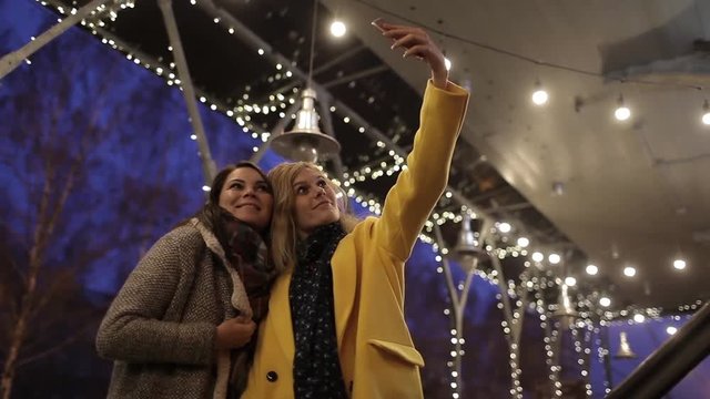 Friends Girls Makes Selfie on a Phone in a Night City