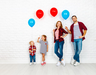 Happy family with ballons. mother, father, son, daughter on a white blank wall