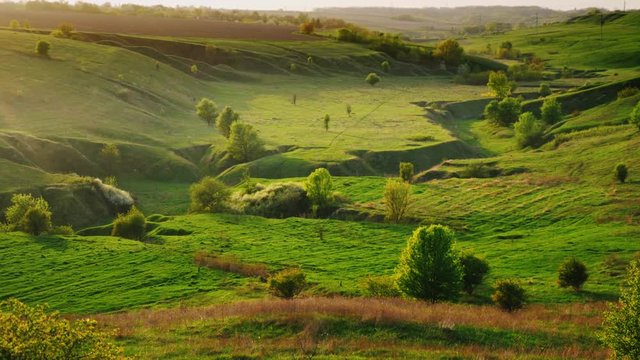 A beautiful landscape with valleys and holmes covered with lush greenery. Excellent pasture and typical European landscape. Time before sunset
