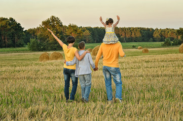 Happy parents with children at sunset