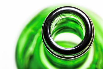 Green glass wine bottle closeup isolated on white.