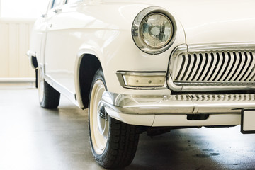 Obraz na płótnie Canvas Classic car with closeup on headlights. Vintage vehicle front detail
