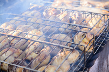 Champignon white mushrooms grilled on grill or barbecue in smoke coals