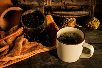 Cup coffee and coffee bean on old wooden background, still life concept