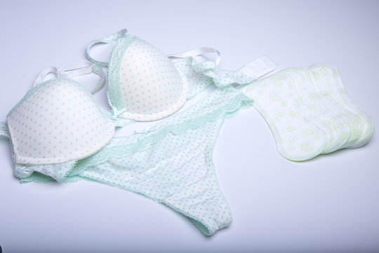 Beautiful female underwear. Panties and bra lying on the white background.