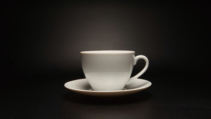 White coffee cup on black background