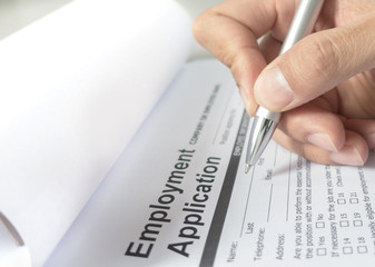 Hand with pen over application form, Filling name in personal details