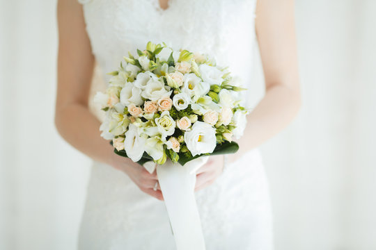 Sweet Wedding Bouquet in the Hands of the Bride