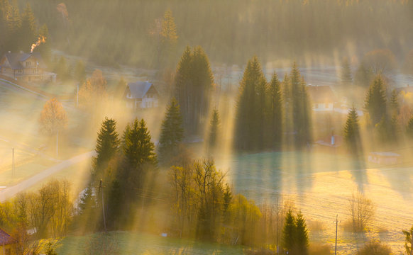 Sunset in the mountains with rays of light and mist