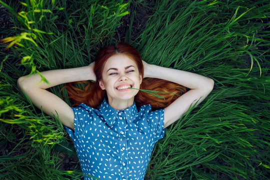 beautiful woman in blue blouse lies on stav