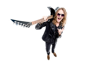 handsome rocker in sunglasses with electric guitar showing rock sign isolated on white, rock star guitar concept