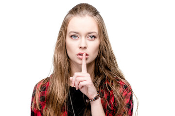 Naklejka premium portrait of young attractive woman with silence gesture looking at camera isolated on white