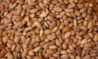 Pile of almonds close-up as background. oriental market