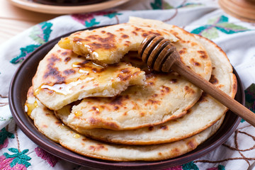 Thin pita with honey on a plate