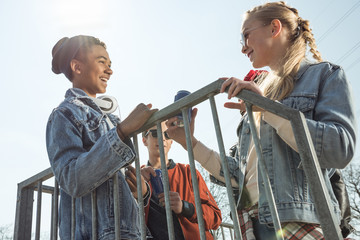 teenagers having fun and posing in skateboard park, hipster students concept