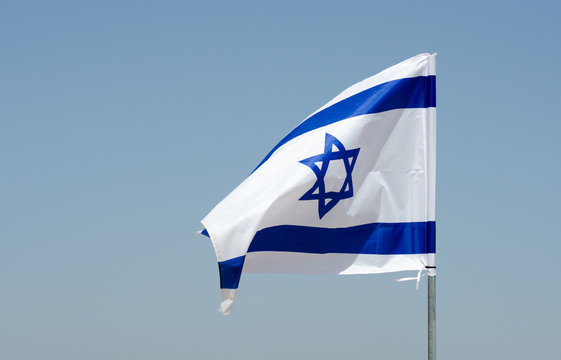 The israeli flag in blue sky at Israeli Independence day