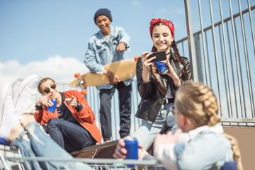 Fototapeta premium Teenagers group having fun together on ramp at skateboard park