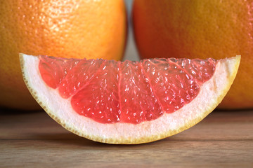 Closeup of red grapefruits on a wooden table