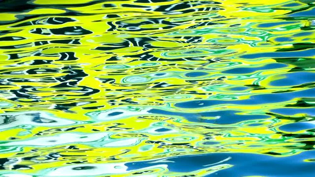 Hypnotic reflexes of bright colors on the surface sea water.