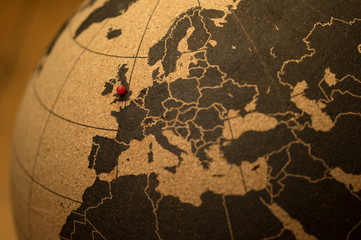 Red pin indicating Birmingham, England on a cork globe